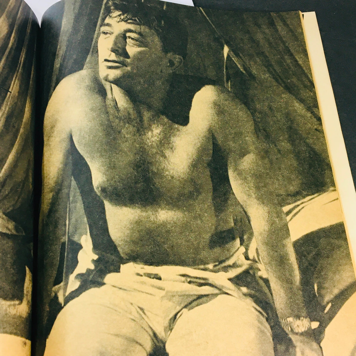 Vintage image from the VTG Modern Screen Magazine December 1964 featuring a shirtless man with a contemplative expression, showcasing the style and charm of the 1960s.