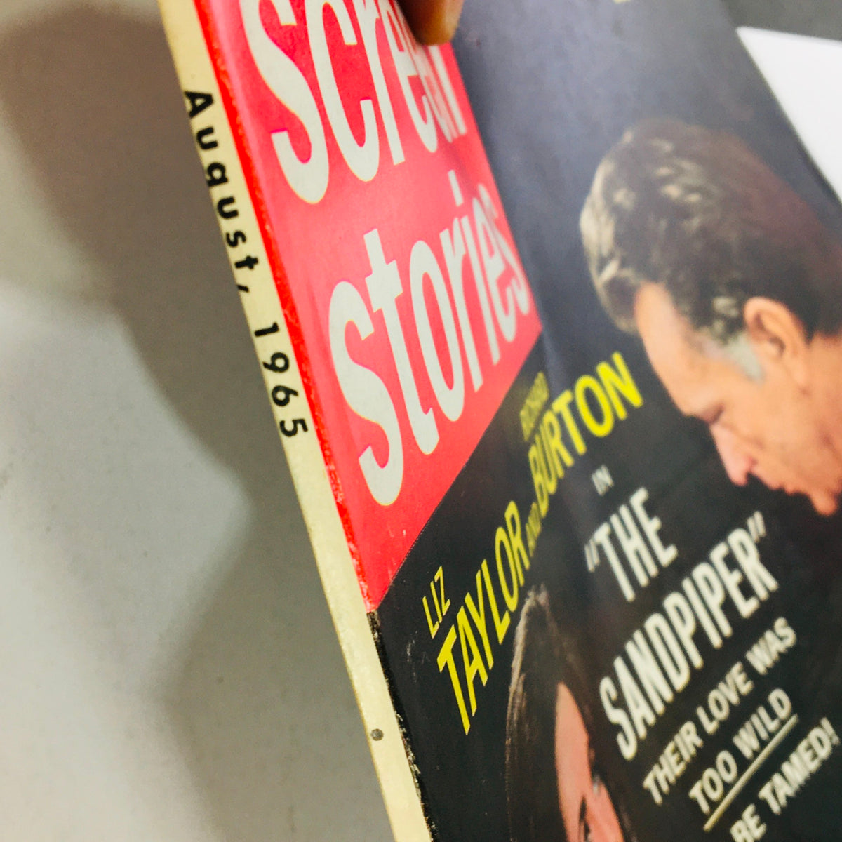 Side view of VTG Screen Stories Magazine August 1965 highlighting the publication date and featuring Liz Taylor and Richard Burton on the cover, related to their film 'The Sandpiper'.