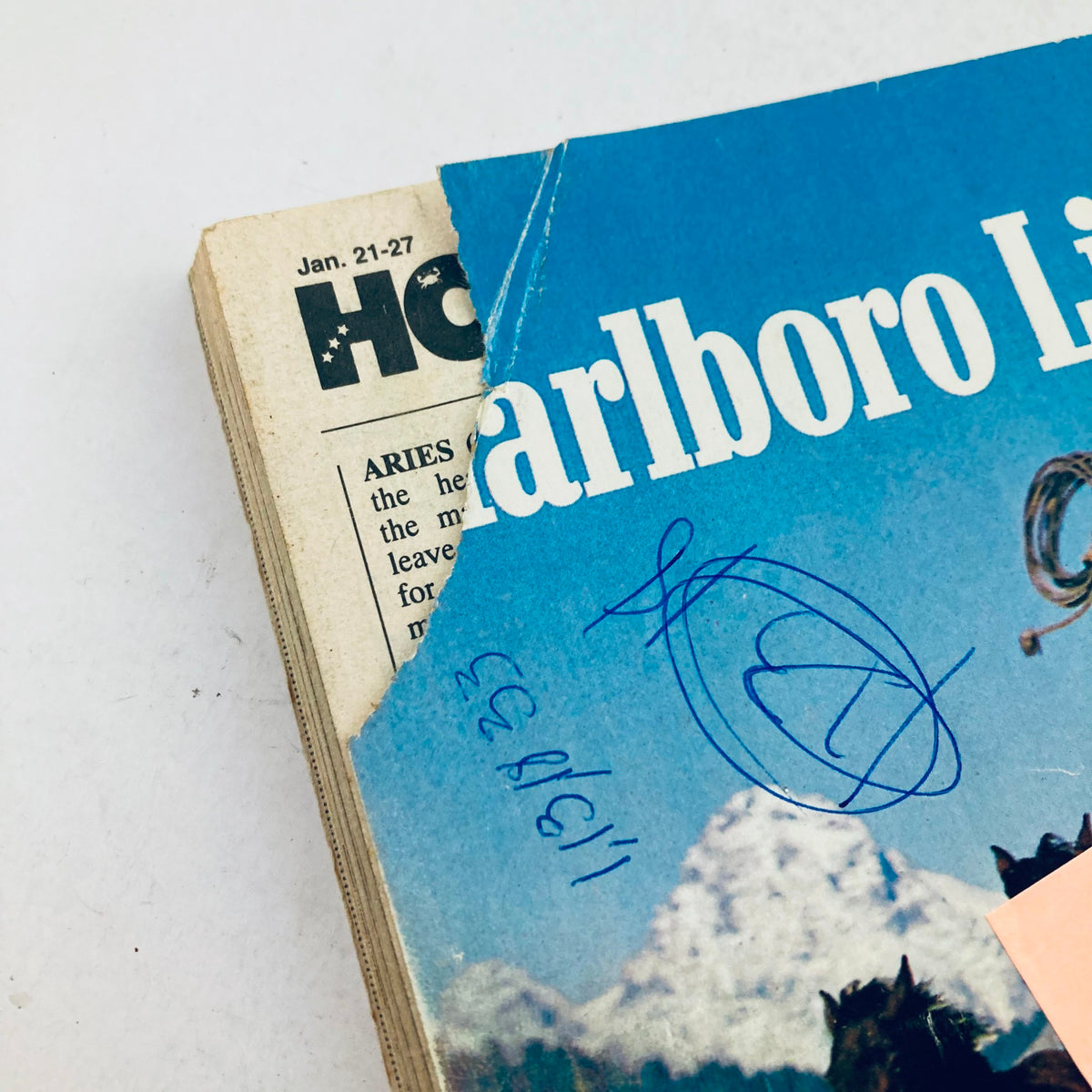 Close-up of the corner of a TV Guide magazine from January 21, 1989 featuring Elvis Presley, showcasing a torn edge and visible handwriting. Ideal for collectors of vintage magazines and memorabilia.