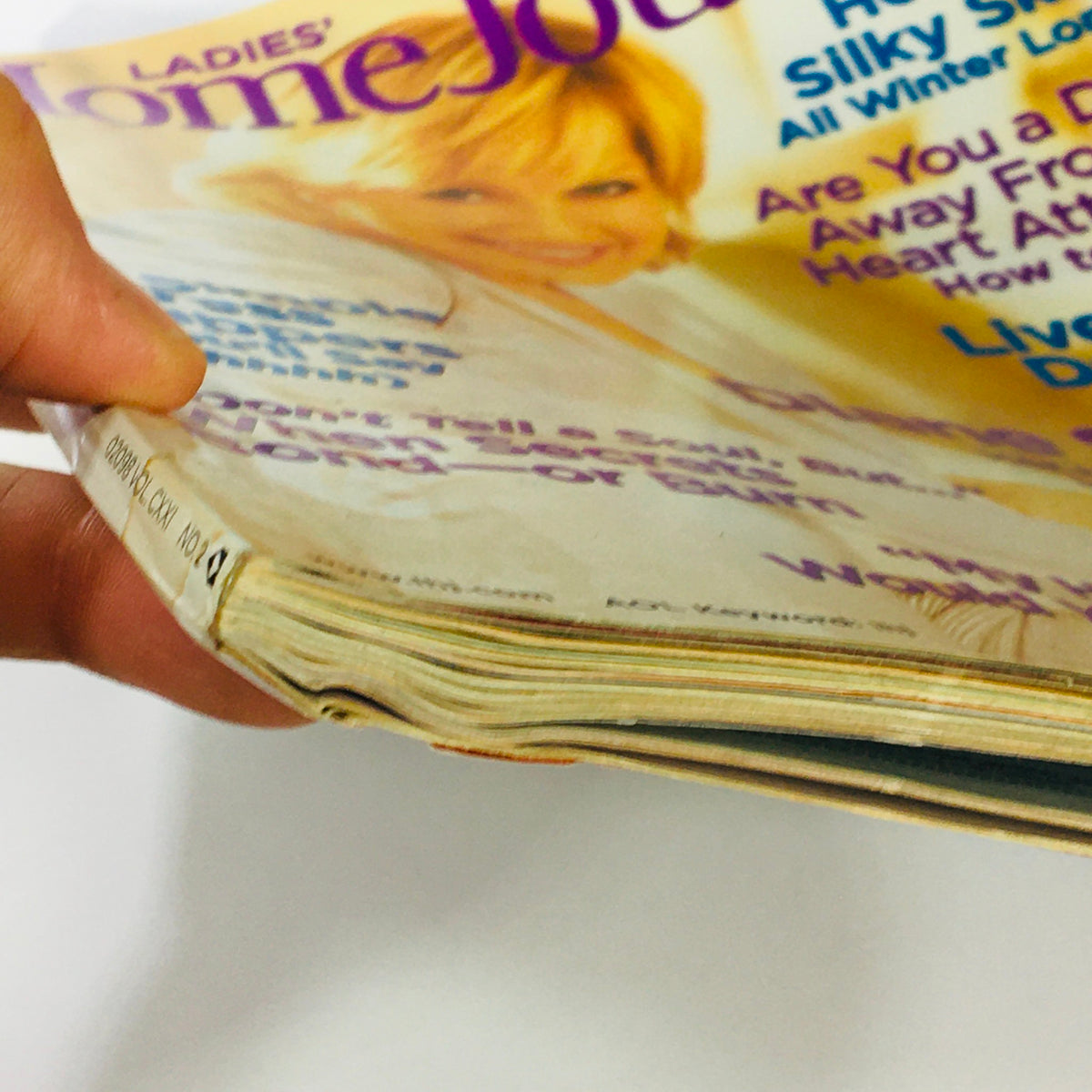 Close-up view of the edge of Ladies' Home Journal Magazine February 2004, illustrating signs of wear yet retaining its collectible value.
