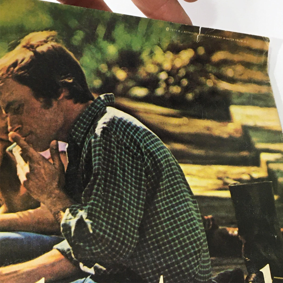 VTG Photoplay Magazine September 1971 featuring a candid image of a young man with dark hair, wearing a plaid shirt, and smoking a cigarette. The background is blurred, highlighting the nostalgic vibe of vintage publications.