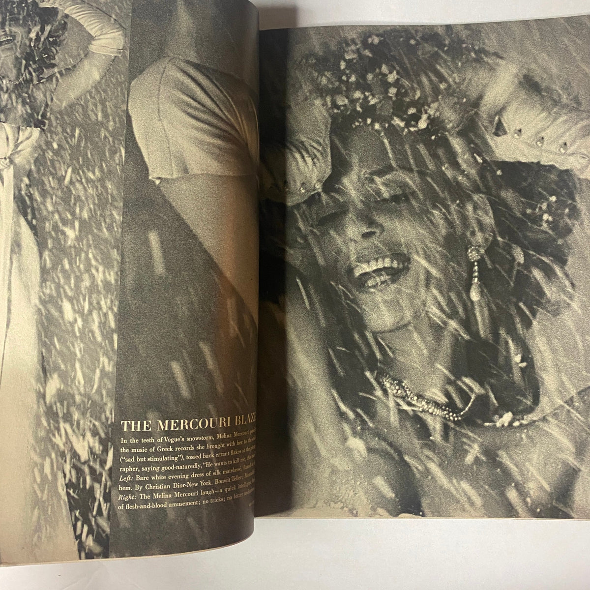 A fashion editorial in Vogue Magazine December 1962, highlighting a glamorous model draped in a dress amidst falling snow, capturing the holiday spirit.