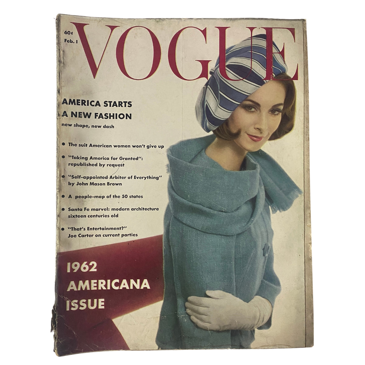 Vogue Magazine cover from February 1, 1962 featuring Wilhelmina Cooper, styled in a sea foam green coat and striped headscarf, highlighting the theme 'America Starts a New Fashion' alongside the statement '1962 Americana Issue'.