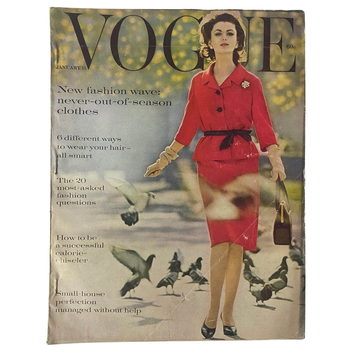 Cover of Vogue Magazine January 15, 1961 featuring a model in a red suit with a bow tie and a flower brooch, surrounded by pigeons, illustrating fashion trends of the era.