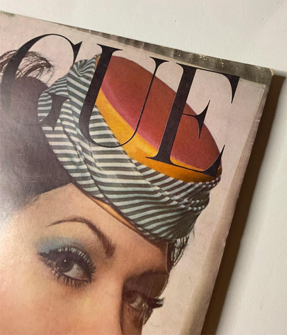 Close-up view of the Vogue Magazine March 1, 1961 cover, highlighting the hat design and makeup details of Isabella Albonico, by Irving Penn.