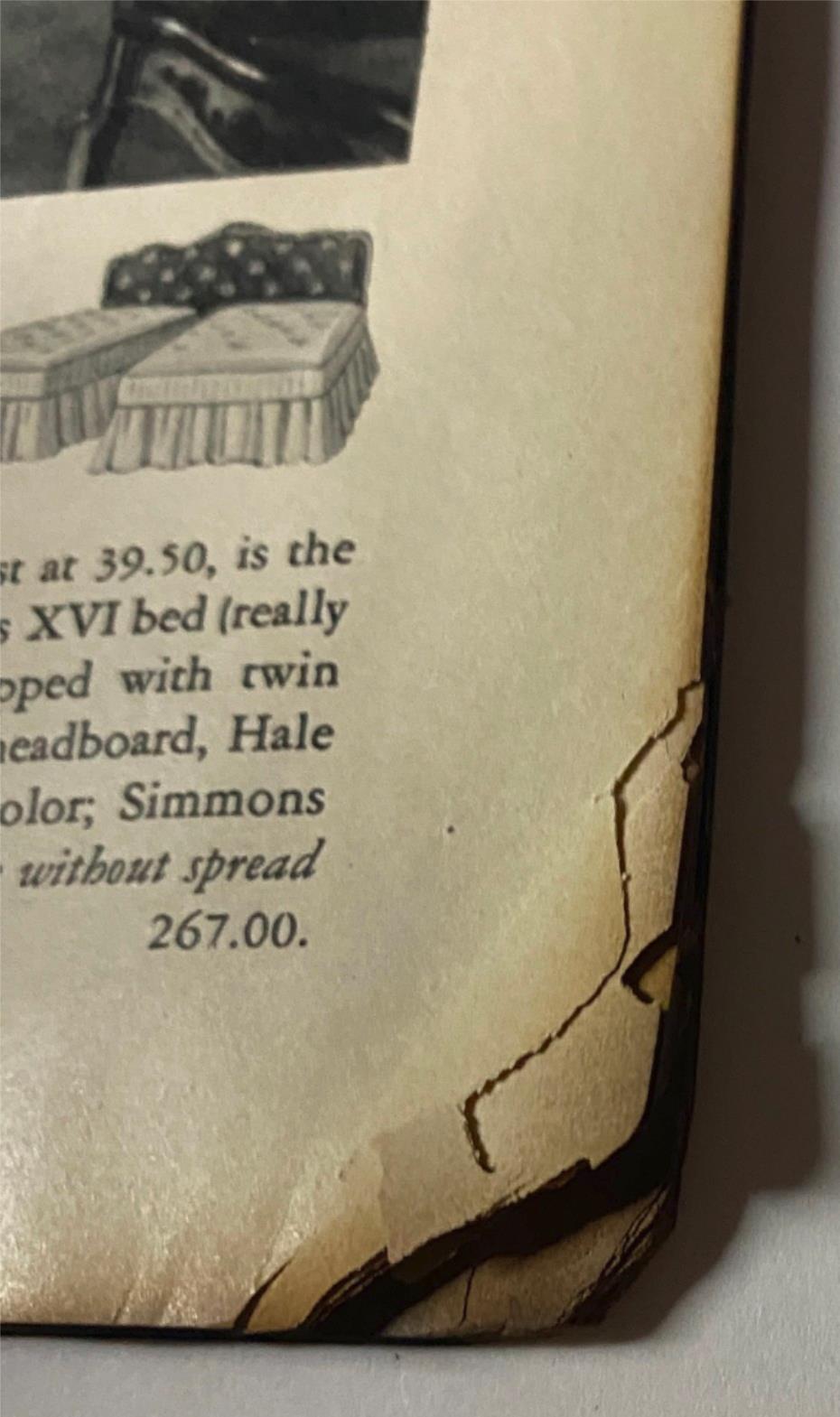 Close-up of the damaged corner of an interior page from Vogue Magazine May 1, 1938, displaying notable wear and aging.