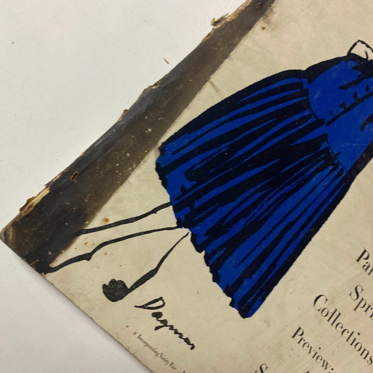 Close-up of Vogue Magazine April 1, 1947 cover highlighting the blue dress illustration and details from the Paris Spring Collections. Features the signature 'Dagner' in the corner.