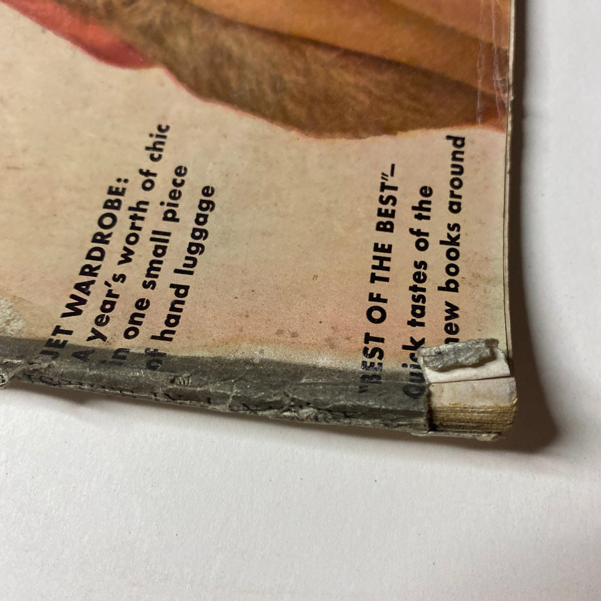 Close-up of the spine of Vogue Magazine January 15, 1962, highlighting the classic design and slight damage that portrays its vintage condition.