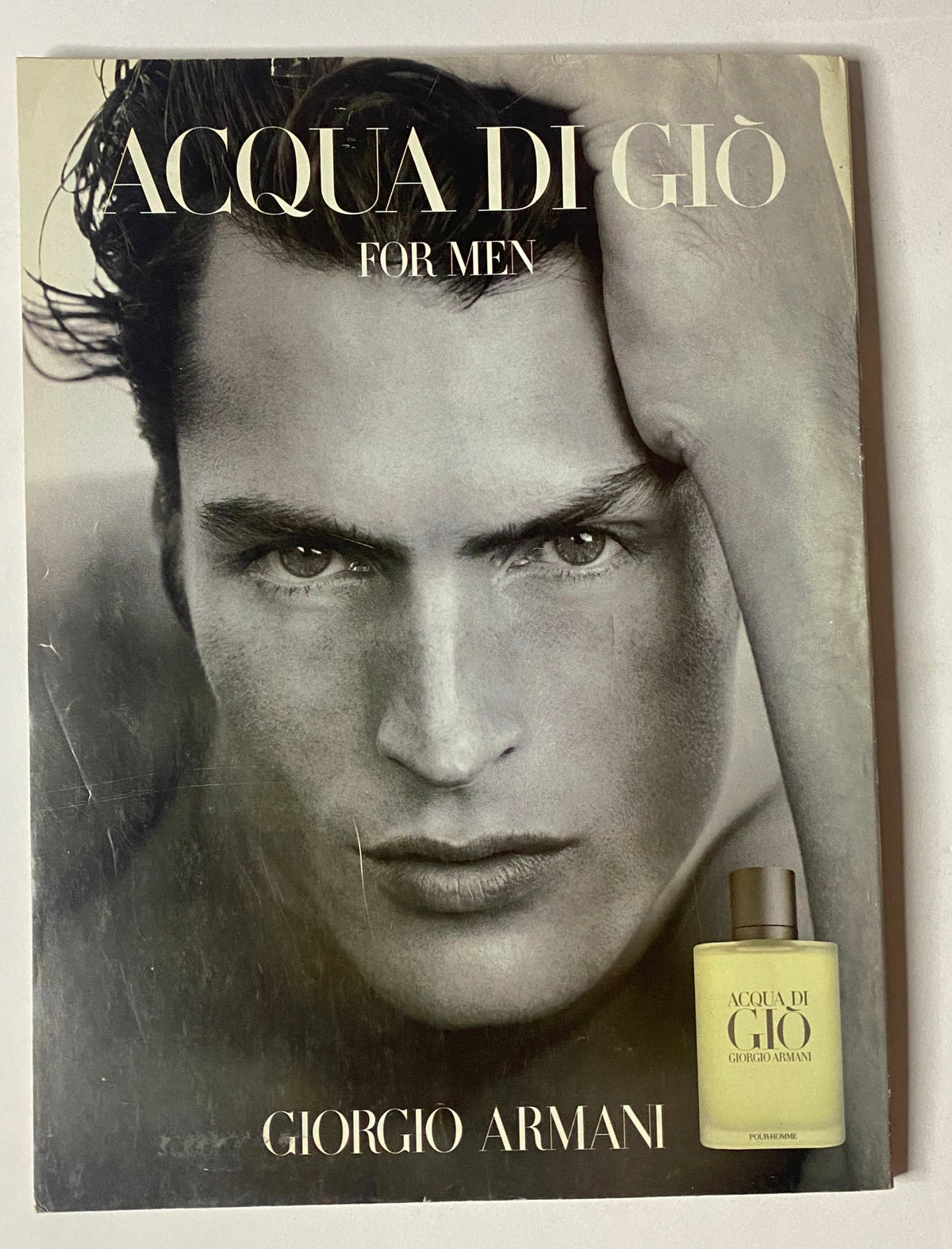 Cover of Acqua di Giò for Men by Giorgio Armani showcasing a striking male model, reflecting the brand's elegance and sophistication.
