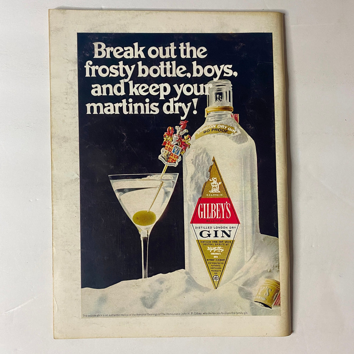 Vintage advertisement for Gilbey's Gin featured in The New Yorker Full Magazine March 29, 1969 with a stylish martini and the slogan "Break out the frosty bottle, boys, and keep your martinis dry!"