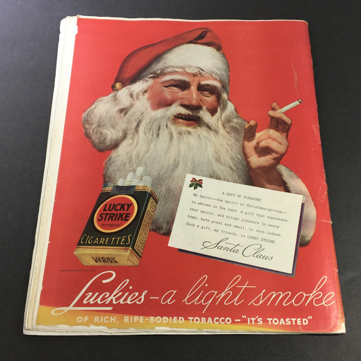 Collier's Magazine December 12, 1936 cover featuring a vintage advertisement for Lucky Strike cigarettes. The image showcases Santa Claus holding a pack of cigarettes with a festive red background.
