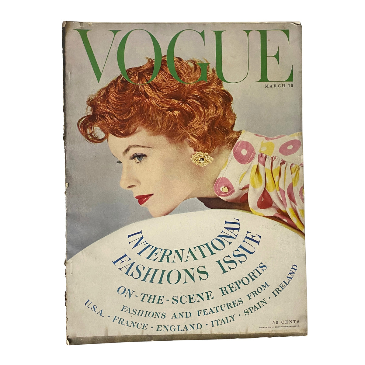 Vogue Magazine March 15, 1954 cover featuring Fern Tailer, showcasing early 1950s fashion with a chic hairstyle and elegant attire. A vintage collectible edition presenting international fashions and cultural insights.