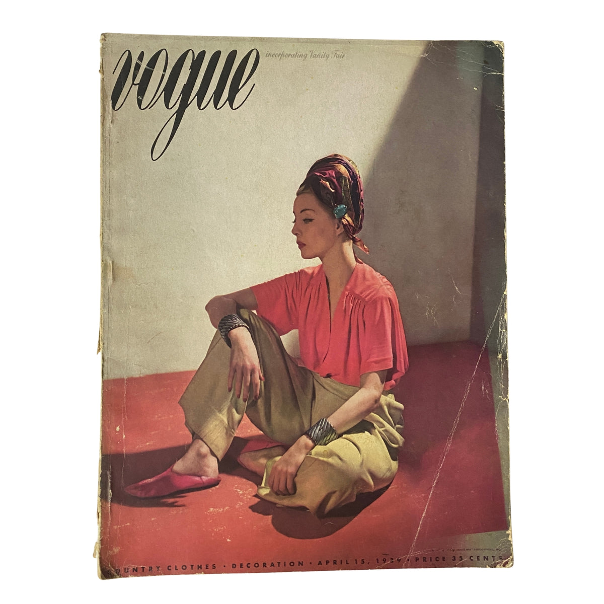 Cover of Vogue Magazine April 15, 1939 featuring a model in a pink top and khaki pants, photographed by Horst P. Horst, highlighting mid-century fashion aesthetics.
