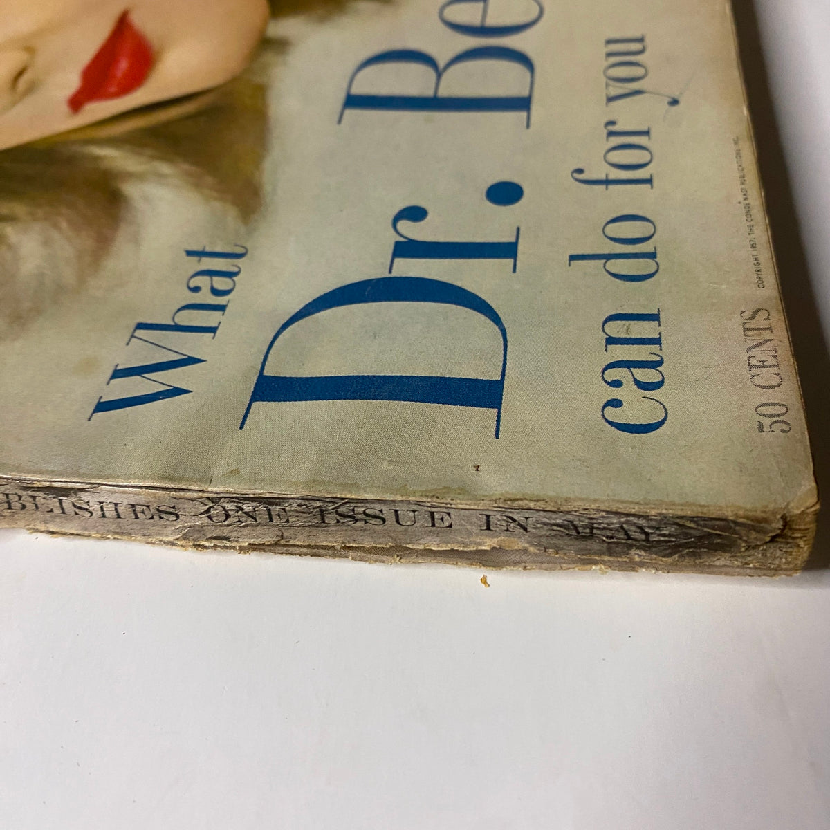 Cover detail of Vogue Magazine May 1957, featuring Ann Klem photographed by Irving Penn, showcasing vintage typography and design elements including 'What Dr. Beauty can do for you'.
