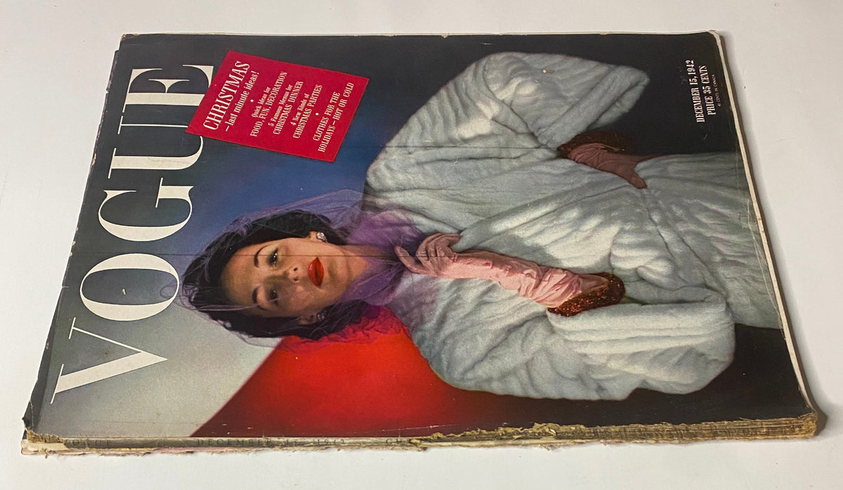Alternate view of Vogue Magazine from December 15, 1942, displaying a model in a white fur coat, emphasizing the 'Christmas' theme with a striking red background and vintage aesthetic.