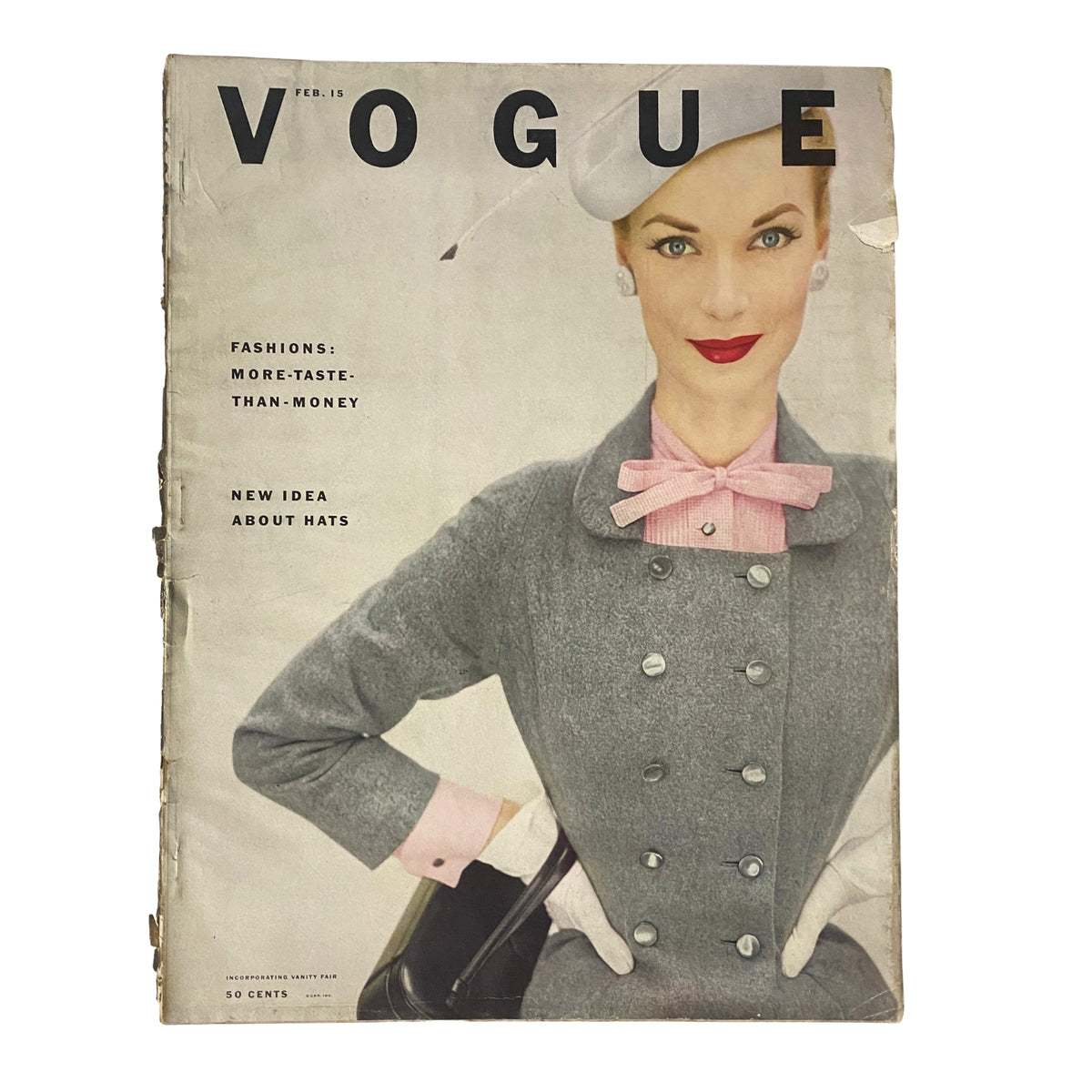 Cover of Vogue Magazine dated February 15, 1952, featuring Janet Randy in a stylish grey outfit with a bow tie and hat, photographed by Clifford Coffin, showcasing early 1950s fashion.