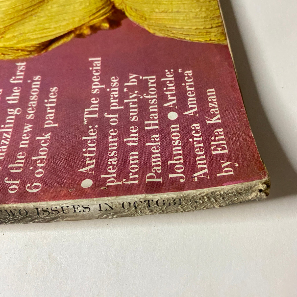 Condition detail showcasing the spine of Vogue Magazine October 1, 1962 Tilly Tizzani Cover by Bert Stern, highlighting shelf wear with visible fraying, emphasizing its authenticity as a collectible item.