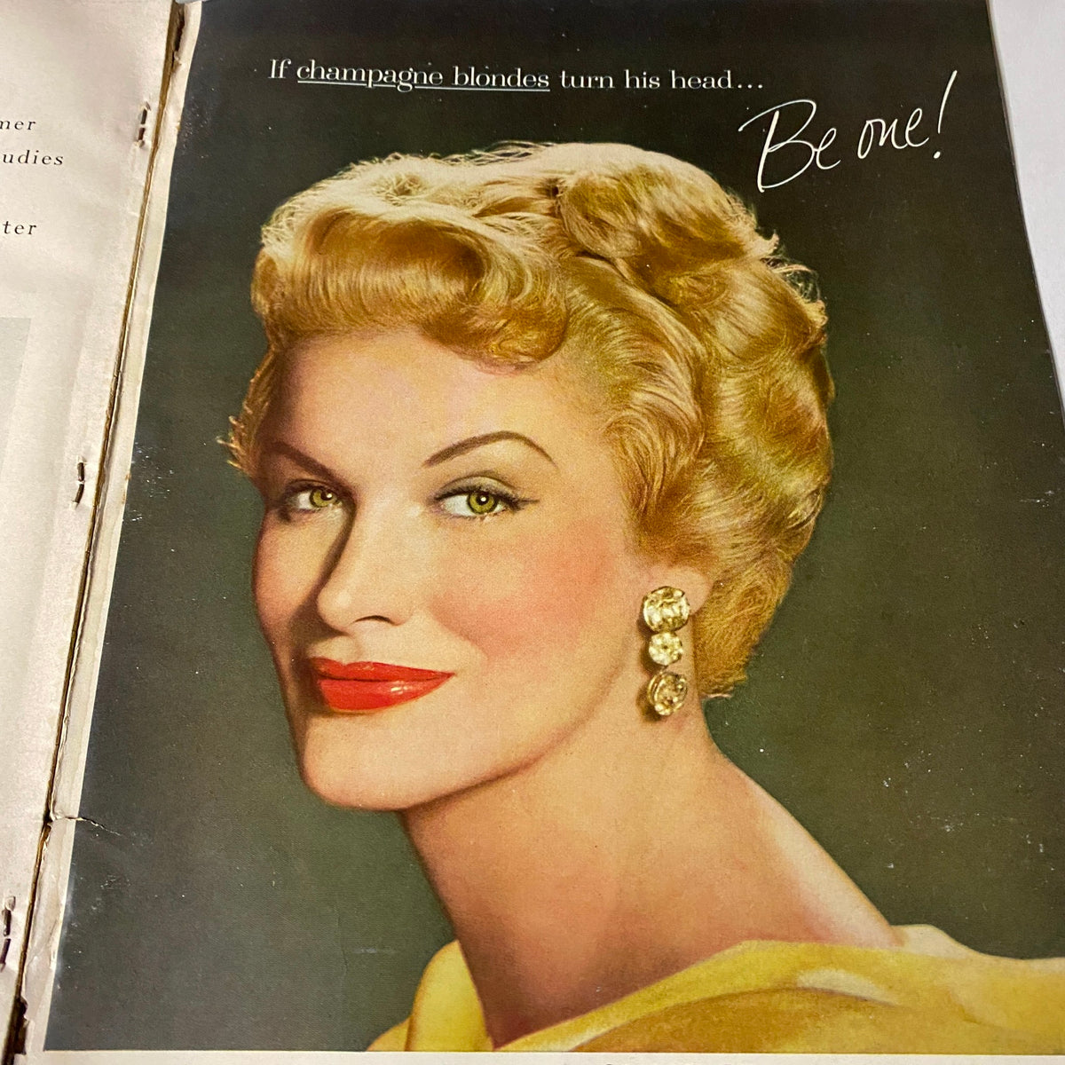 Vogue Magazine July 1957 Joanna McCormick Cover by Karen Radkai with a glamorous blonde model promoting a beauty product, embodying 1950s style and allure.