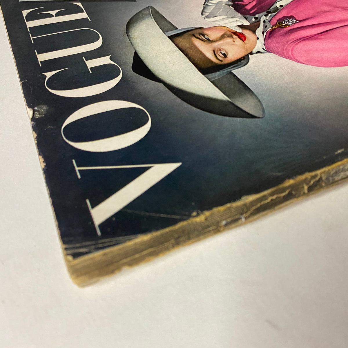 Close-up of the Vogue Magazine April 15, 1942 cover, illustrating the quality and details of 'Our Ration-al Lives' design, with a model in a pink outfit and stylish hat.