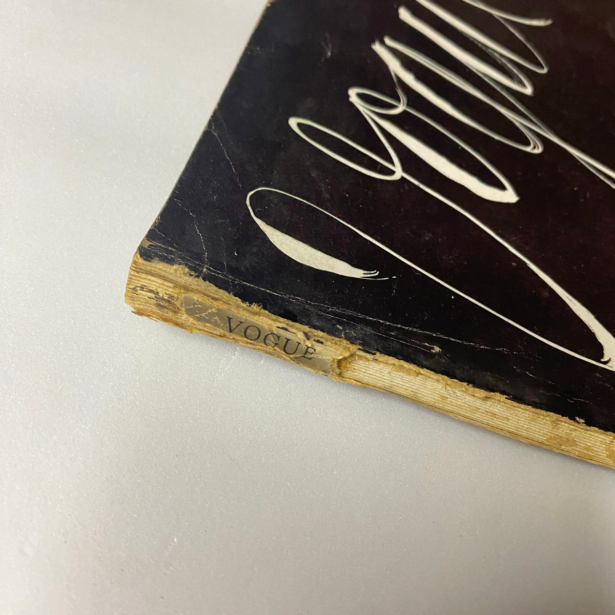 Spine detail of Vogue Magazine April 1, 1939, showcasing the title 'Vogue' with slight wear reflecting its vintage nature.