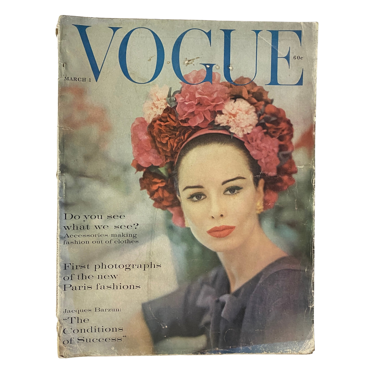 Vogue Magazine March 1, 1960 cover featuring model Sondra Peterson styled with floral accessories, emphasizing early 1960s fashion. Captured by photographer Karen Radkai, the cover highlights couture trends from Paris.