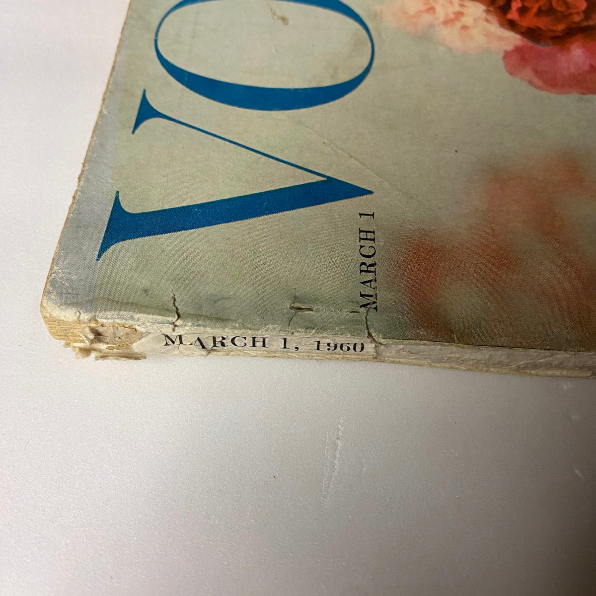 Close-up view of the March 1, 1960 Vogue Magazine spine highlighting the publication date and minor wear, featuring Sondra Peterson on the cover.