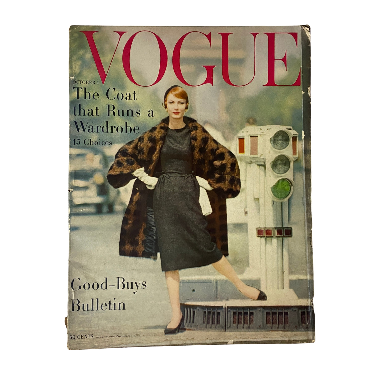 Vogue Magazine cover from October 1, 1957 featuring the title 'The Coat that Runs a Wardrobe' showcasing a model in fashionable attire, photographed by William Klein.
