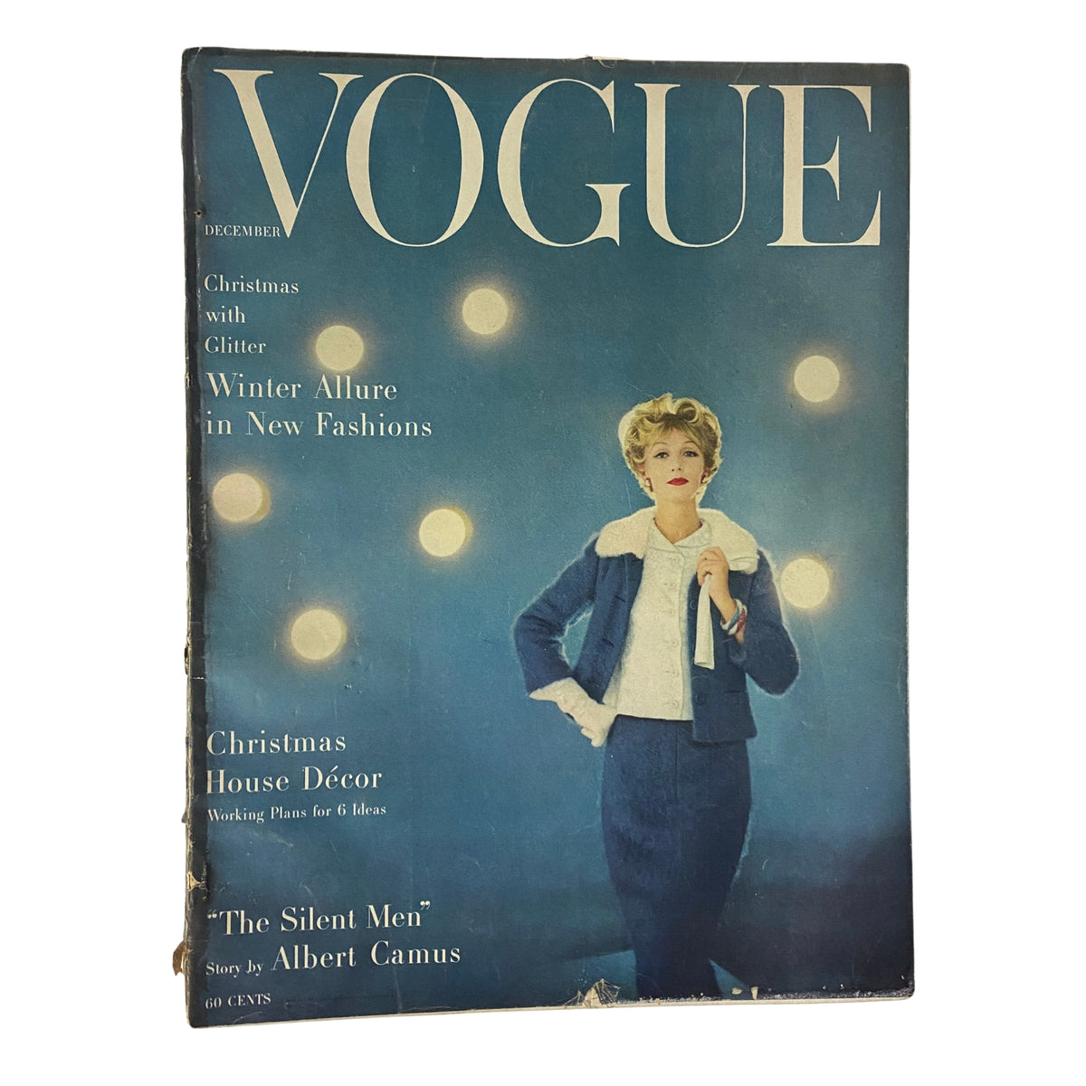 Vogue Magazine December 1957 Gyongyi Armstrong Cover by Karen Radkai featuring a model in a glamorous winter outfit, showcasing holiday-themed fashion and decor.