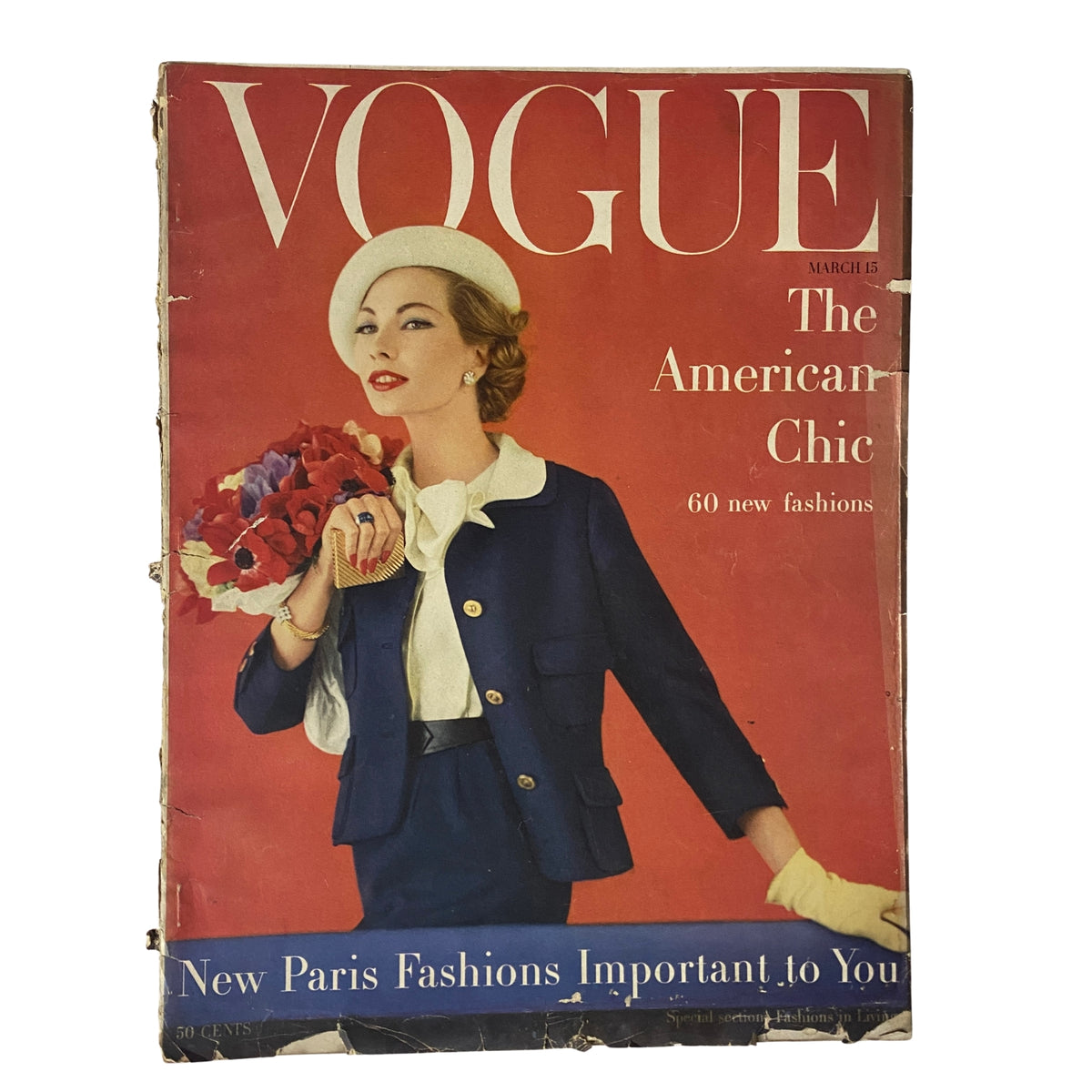 Vogue Magazine March 15, 1957 featuring The American Chic cover, showcasing a stylish woman in a navy outfit holding a bouquet, a representation of mid-century fashion.