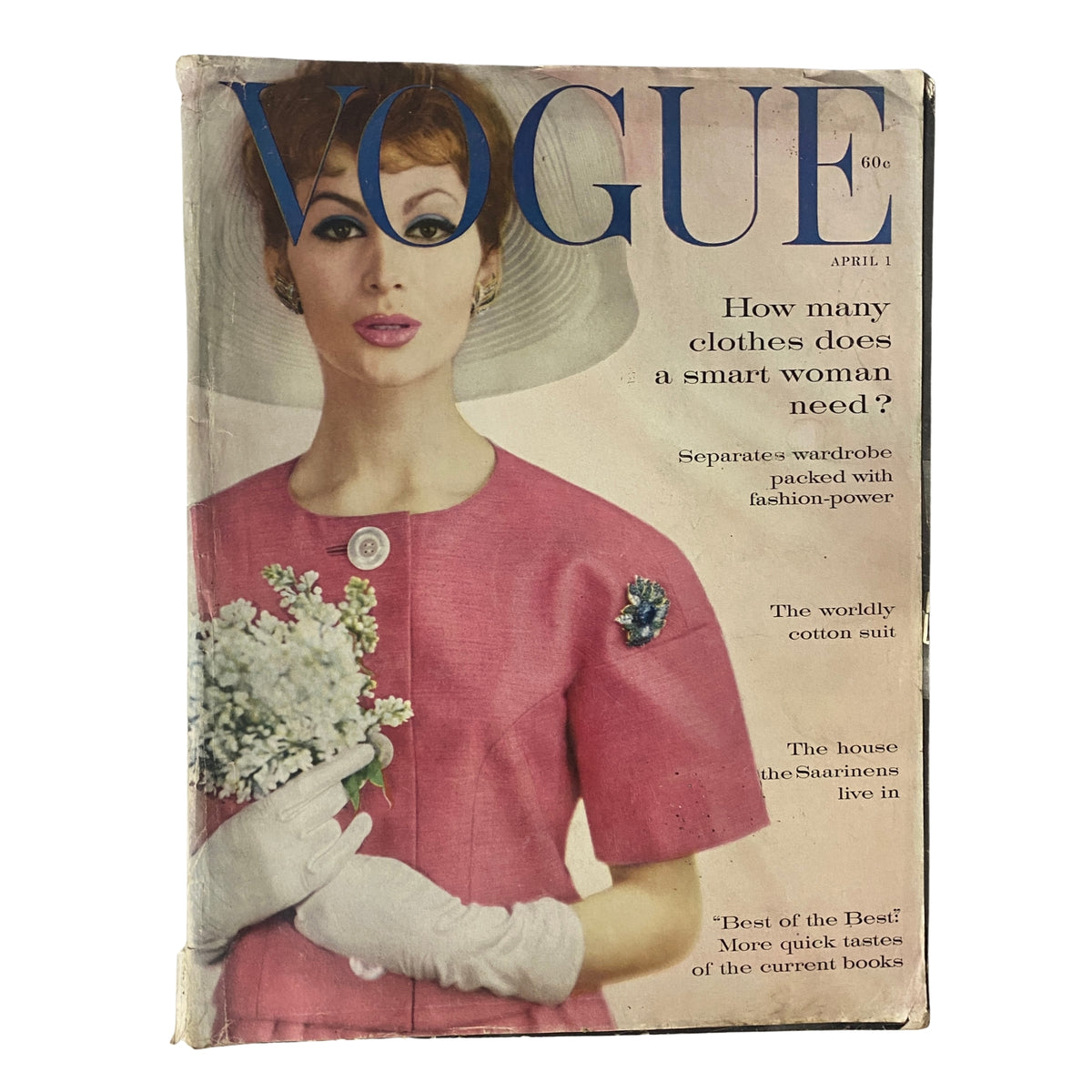 Vogue Magazine April 1, 1960 featuring a stylish model in a pink dress with a sun hat, showcasing couture fashion and editorial content.