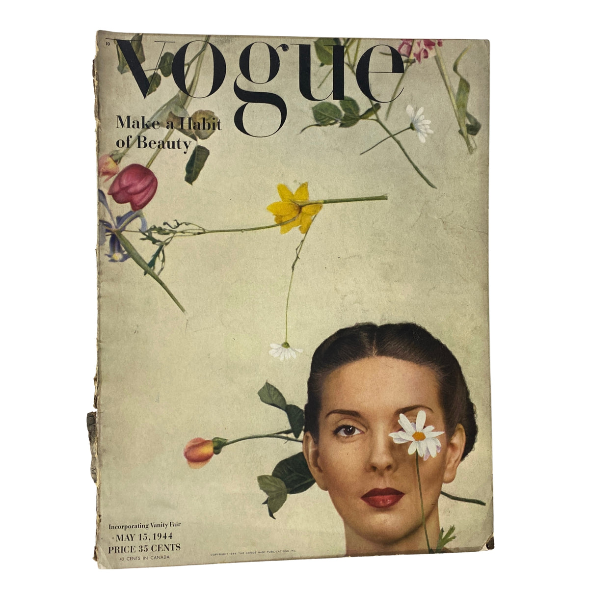 Vintage Vogue Magazine cover from May 15, 1944 featuring Bettina Bolegard, photographed by Gjon Mili. The cover showcases floral elements arranged around Bettina's head, promoting the theme 'Make a Habit of Beauty'.