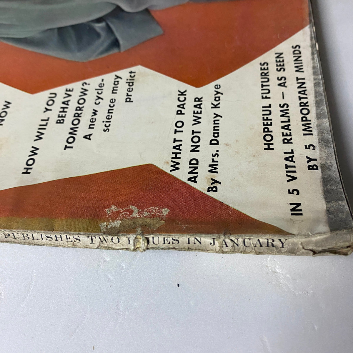 Lower edge of Vogue Magazine January 1, 1962 detailing list of articles including 'What To Pack and Not To Wear' by Mrs. Danny Kaye.