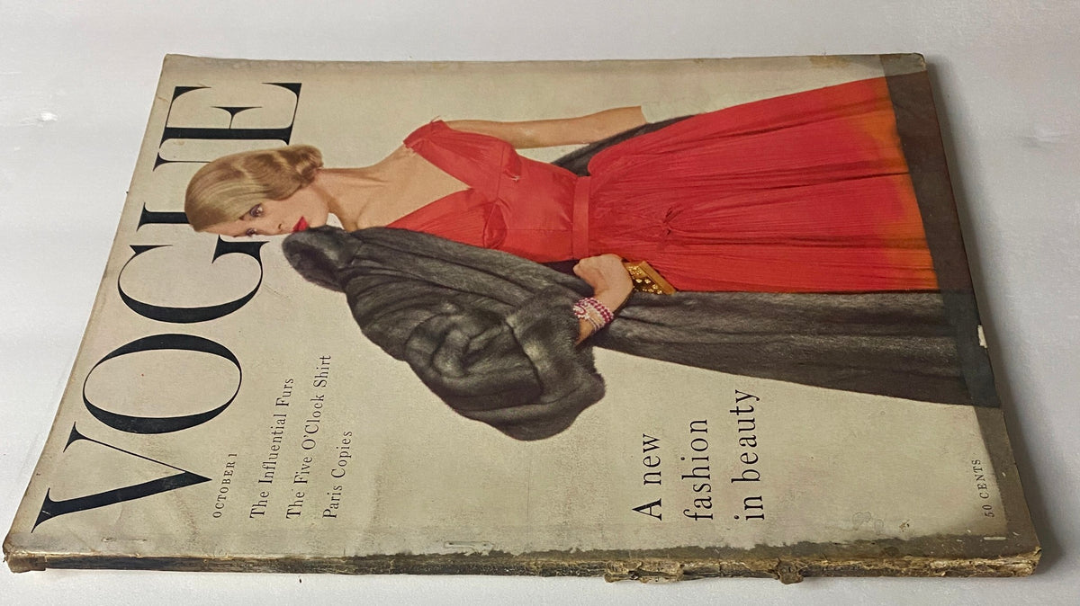 Vintage Vogue Magazine October 1, 1954 cover highlighting model Jean Patchett in a dramatic pose, wearing a red dress and fur coat, emphasizing timeless beauty and fashion.