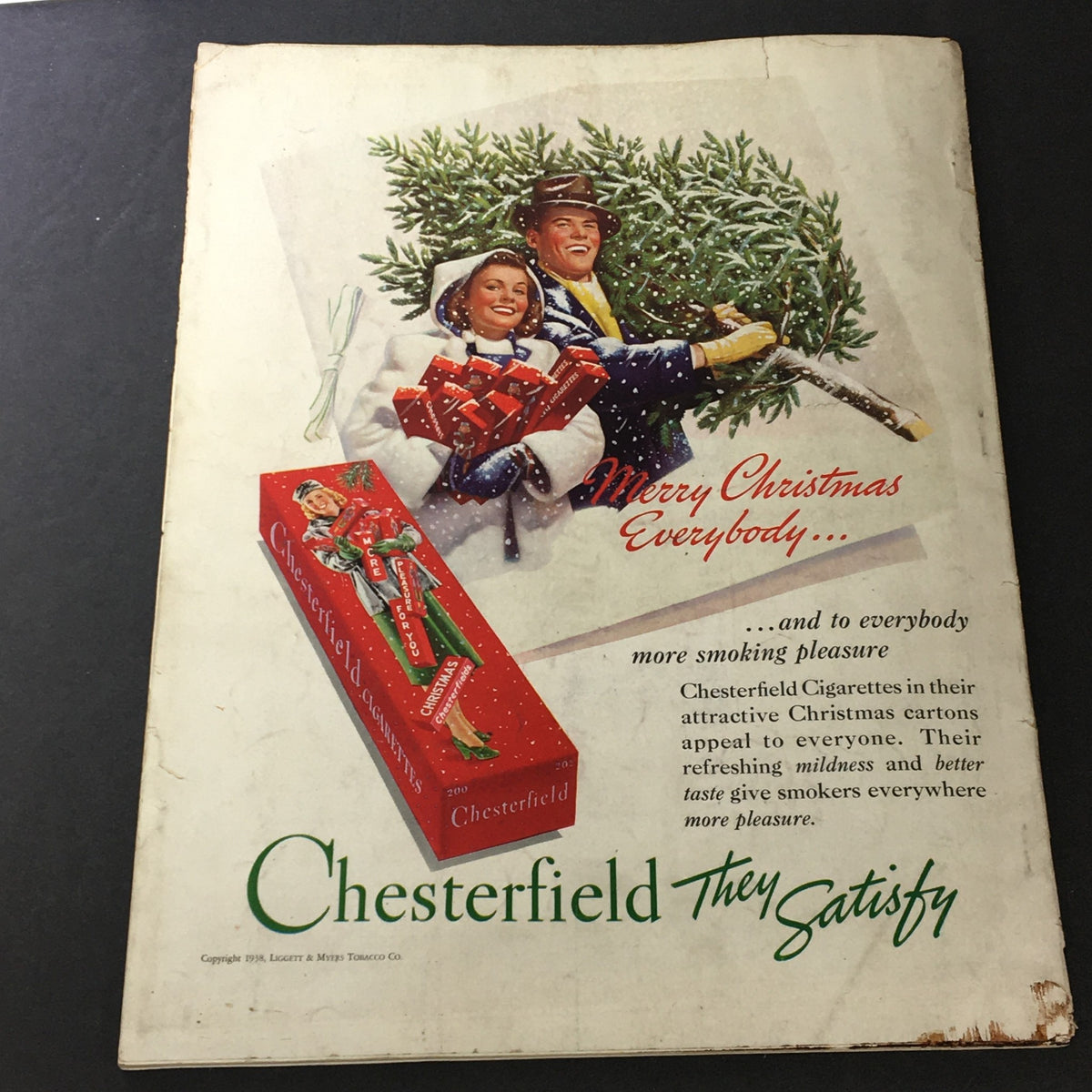 Vintage Christmas advertisement for Chesterfield Cigarettes, depicting a couple carrying Christmas gifts, from VTG The American Home for 1939 Vol XXL #2 The Remodeling of Rural Hill.
