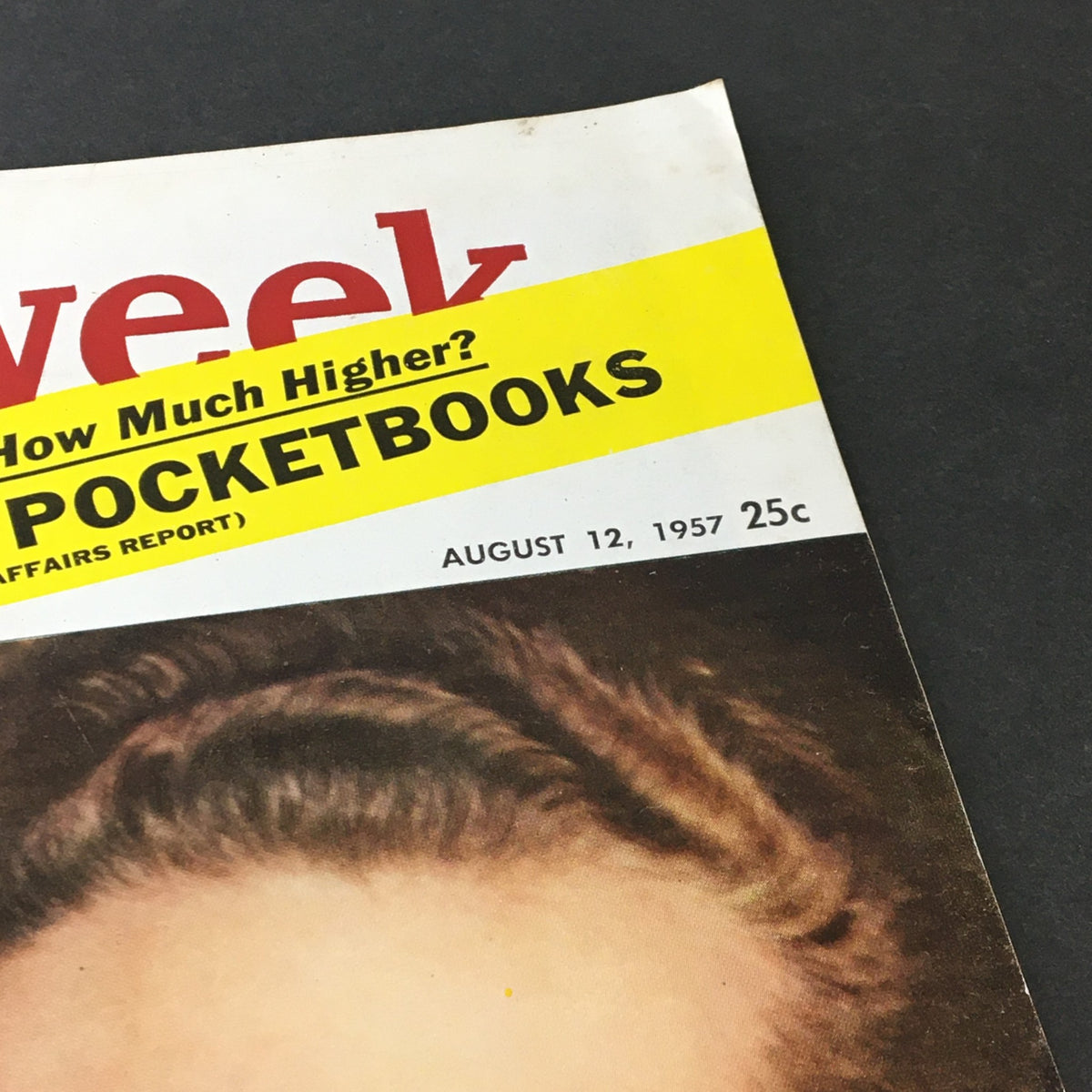 Close-up of the vintage Newsweek magazine from August 12, 1957 featuring the title and publication date, highlighting its historical context related to King of Spain Juan Carlos and Franco.