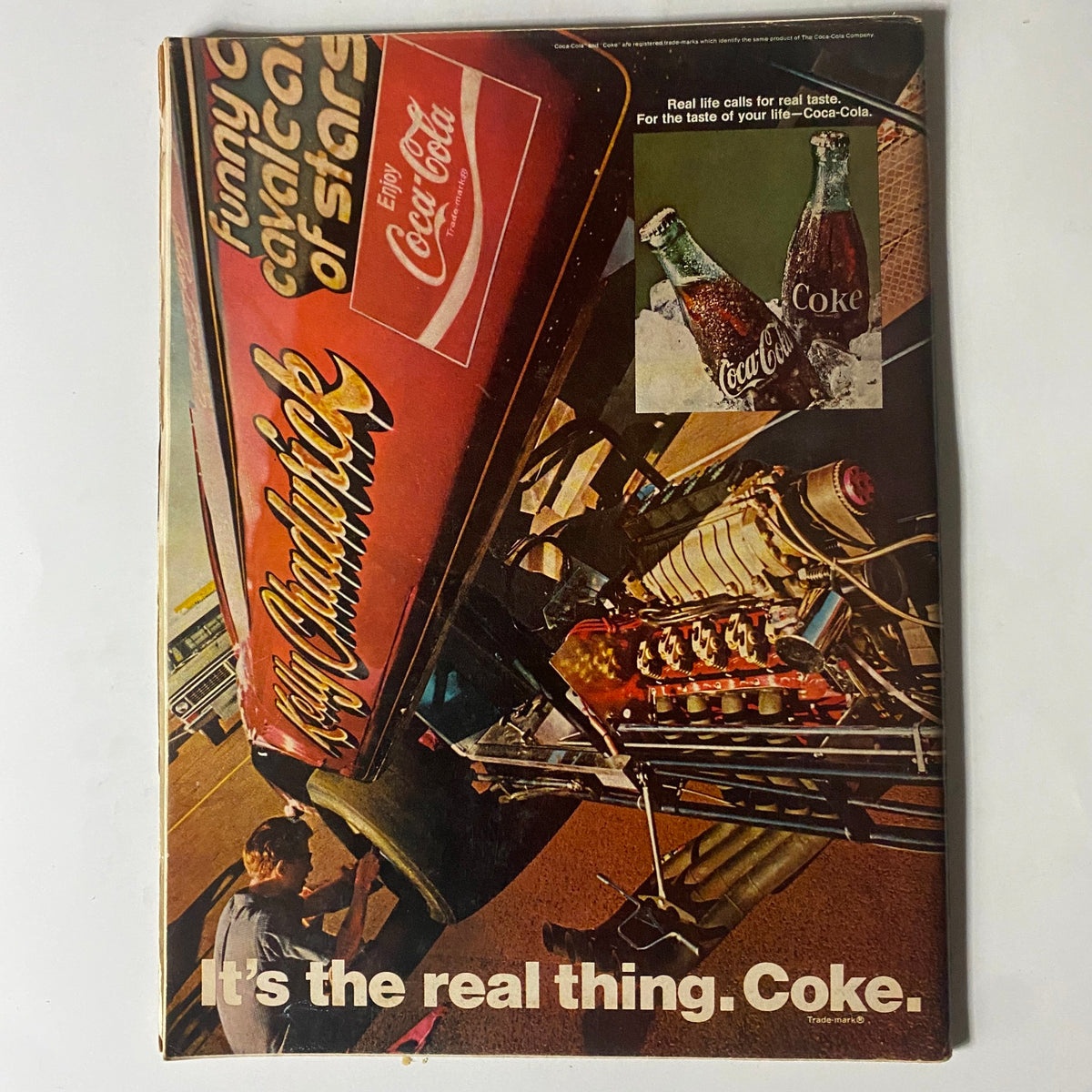 Back cover of VTG Motor Trend Magazine May 1970 featuring a Coca-Cola advertisement and a vintage racing engine, highlighting the nostalgic automotive theme.