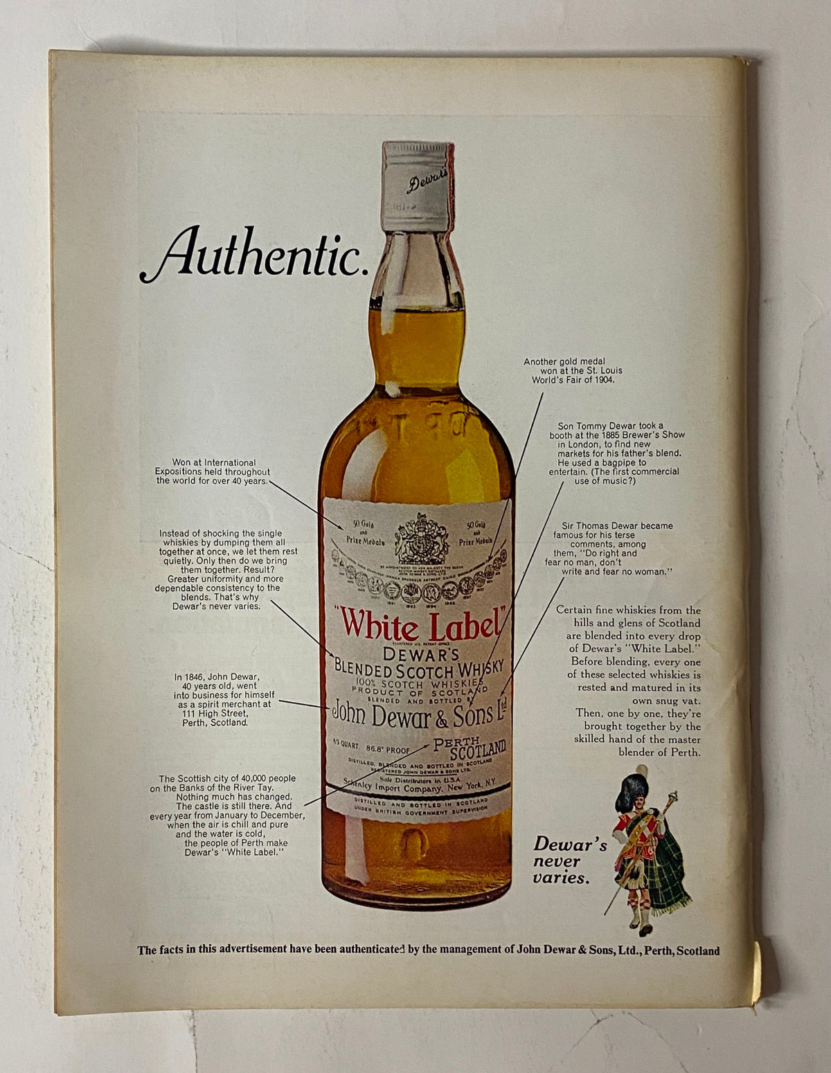 Advertisement for Dewar's White Label Blended Scotch Whisky, labeled 'Authentic', showcasing the bottle design; part of the collection from 'The New Yorker Full Magazine October 25, 1976 Arthur Getz Cover'.