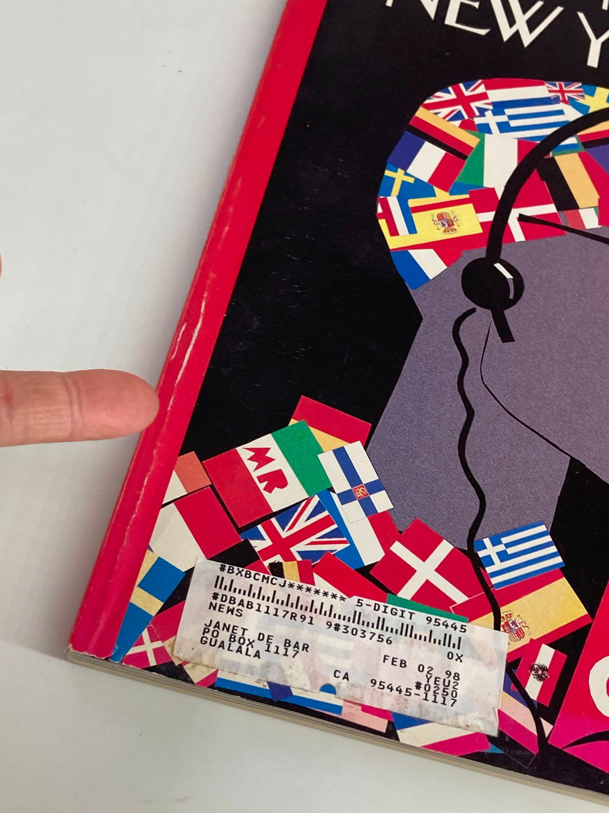 Close-up view of The New Yorker Full Magazine April 28 1997 cover highlighting the Eurocentric theme with a focus on the character's hat decorated with flags and a label.
