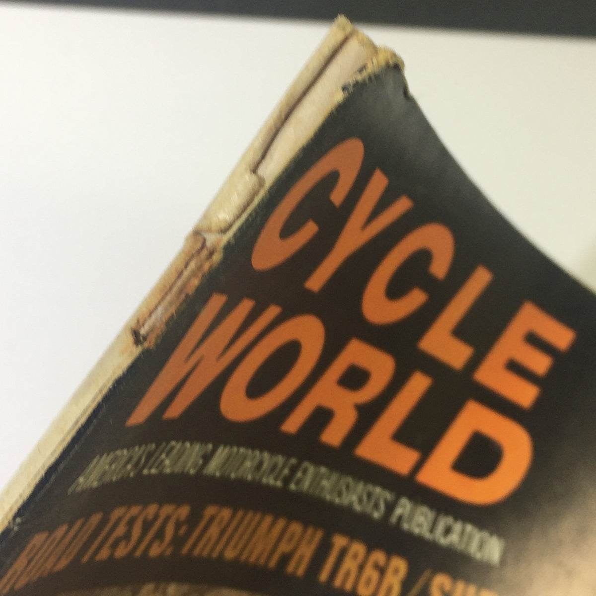Close-up view of the spine of the VTG Cycle World Magazine from March 1969, highlighting the title and details about the Triumph TR6R and Suzuki TS 250 road tests.
