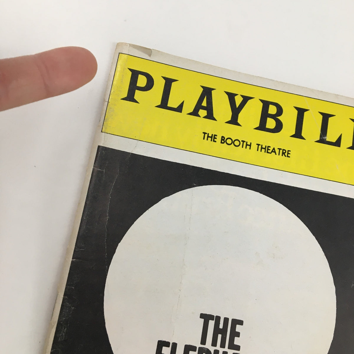 Close-up image of the top section of the 1981 Playbill for The Elephant Man at The Booth Theatre, showing the iconic Playbill logo and part of the cover art.