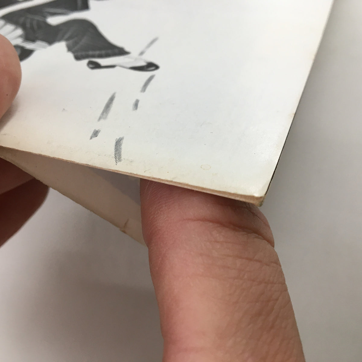 Close-up view of the edge of the 1970 Playbill for 'Sleuth,' illustrating wear typical of vintage publications, including markings on the paper.