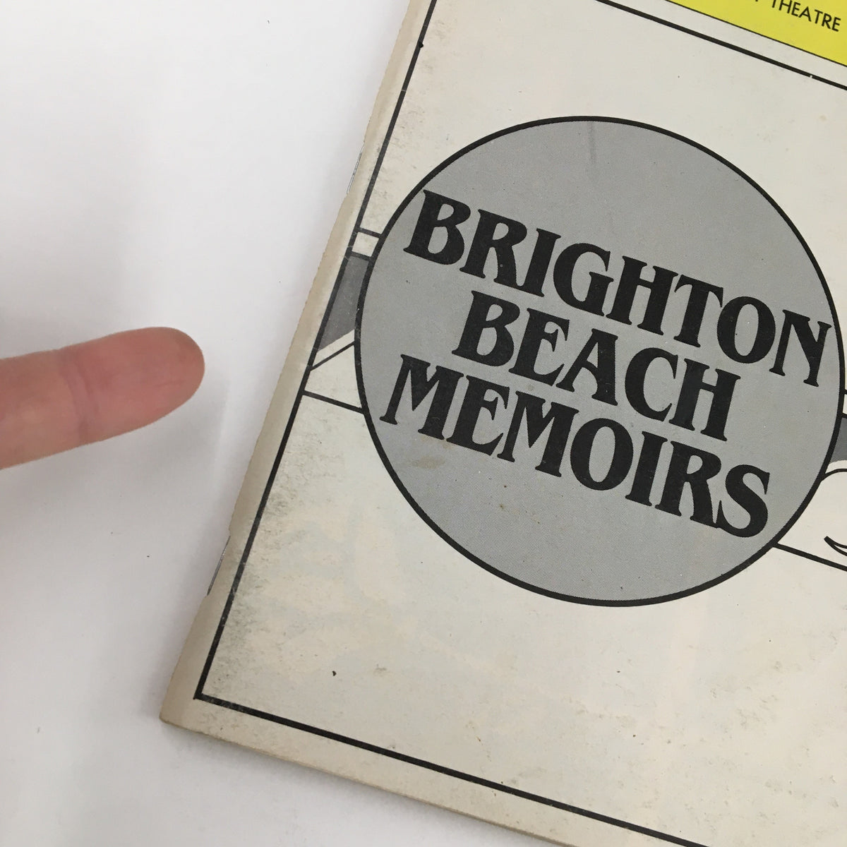 Close-up of the cover of the 1985 Playbill for Brighton Beach Memoirs at the Forty-Sixth Street Theatre featuring a circular logo.