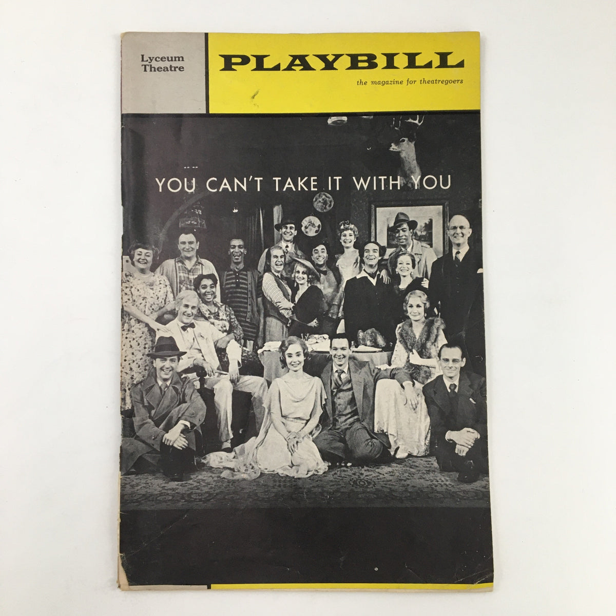 1966 Playbill for You Can't Take It With You displayed on a flat surface, showcasing the cover featuring a cast photo from the Lyceum Theatre production.