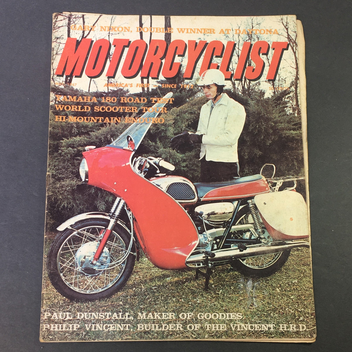 Cover of VTG Motorcyclist Magazine May 1967 featuring Paul Dunstall and Philip Vincent H.R.D., showcasing a red motorcycle displayed outdoors with a man in winter attire.