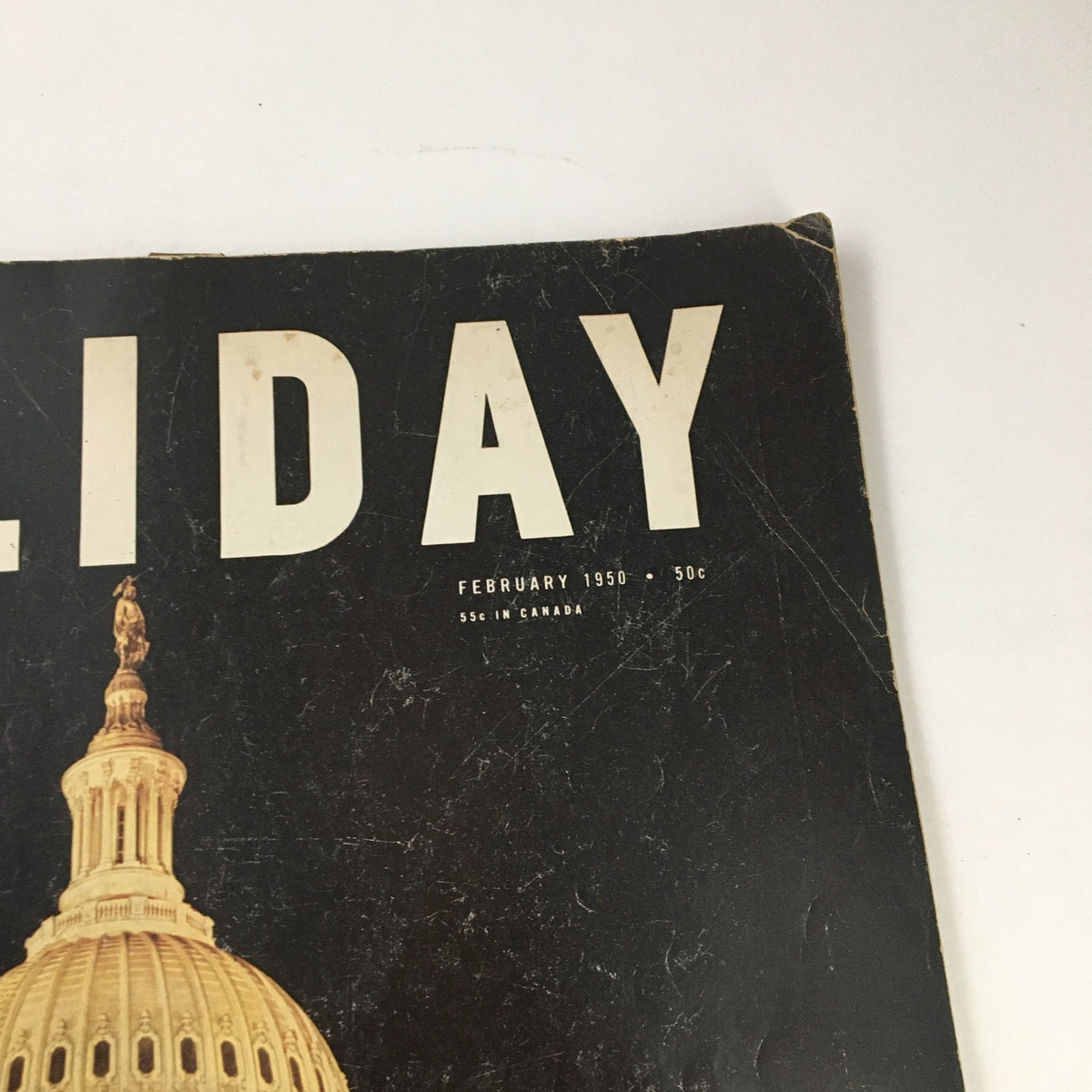 Close-up of Holiday Magazine February 1950 cover showcasing the title and publication date, emphasizing its vintage appeal.