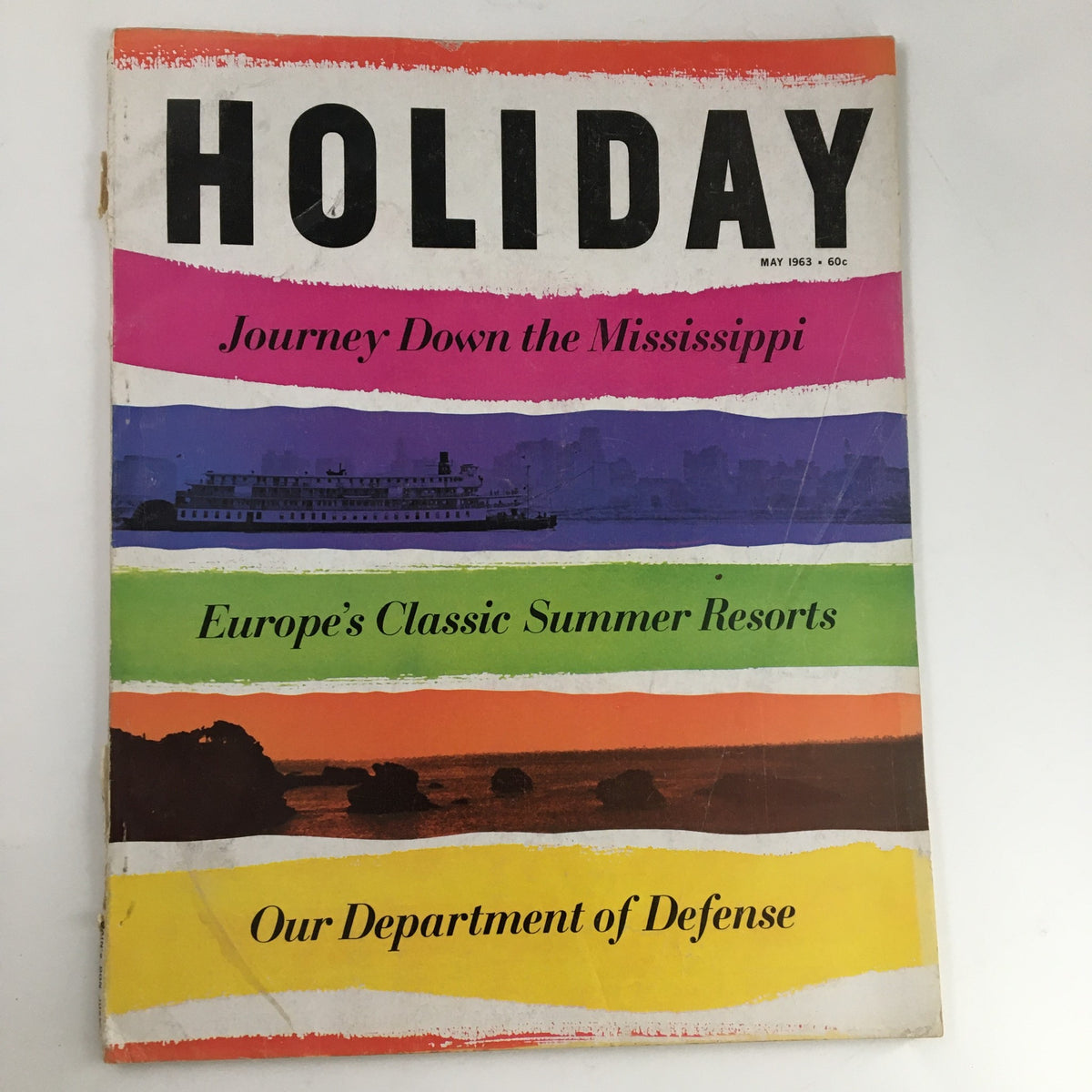 Cover of Holiday Magazine May 1963 featuring vibrant colors and titles including 'Journey Down the Mississippi' and 'Europe's Classic Summer Resorts'.