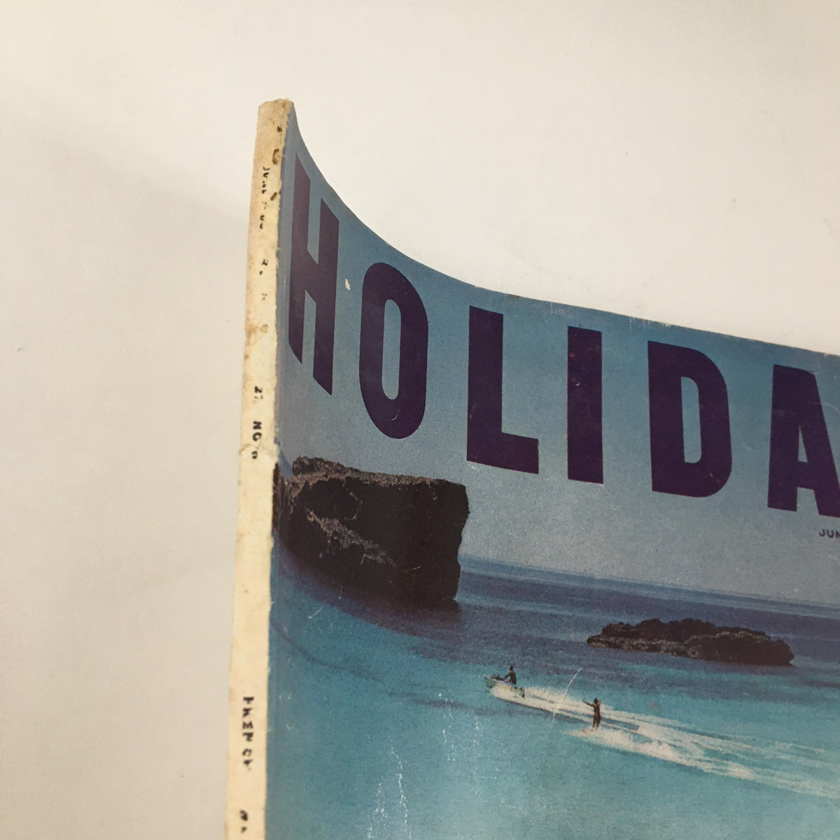 Cover of Holiday Magazine June 1960 featuring a serene beach scene and the title "HOLIDAY" in bold letters, showcasing New York's seafood restaurants.