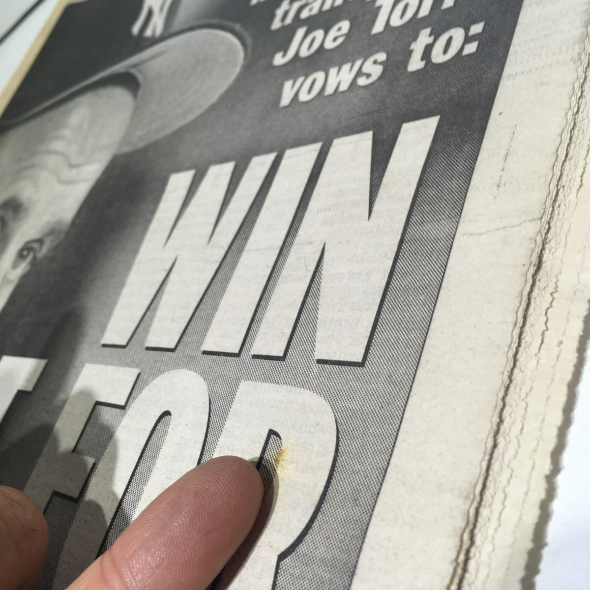 Close-up image highlighting the 'WIN IT FOR FRANK' headline from the New York Daily News, date October 26, 1996, emphasizing Joe Torre's vow in an emotional sports story.