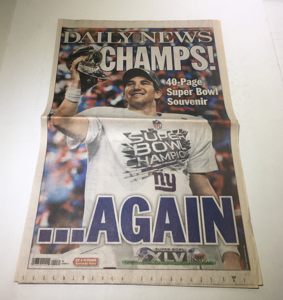 New York Daily News February 6, 2012 front cover featuring Eli Manning celebrating with the Super Bowl trophy, commemorating the NY Giants' victory.