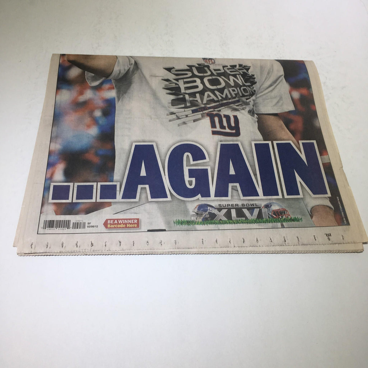 Cover of New York Daily News featuring Super Bowl Champion NY Giants, highlighting the headline '...AGAIN' commemorating Eli Manning's victory on February 6, 2012.